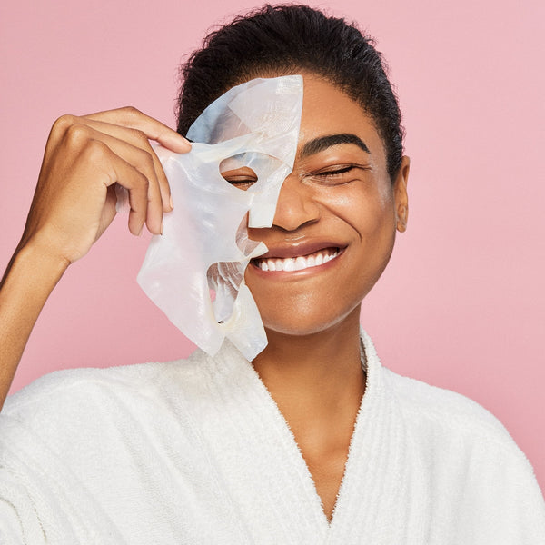 women peeling off her hydration mask